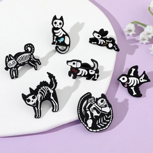 Collection of seven dark aesthetic animal skeleton enamel pins on a minimal display