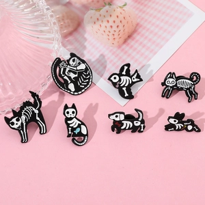 Detail of dark skull animal enamel pins featuring cats and dogs on a pink background