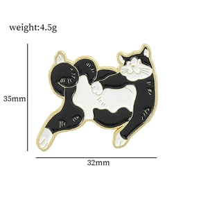 Cartoon black and white kittens enamel pin with weight and dimension details