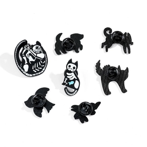 Dark gothic animal skeleton enamel pins featuring cat, dog, and bird bone designs
