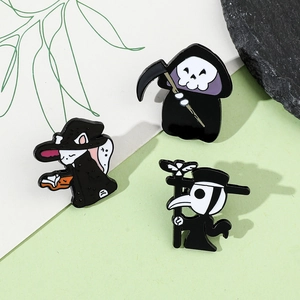 Close-up of gothic enamel pins featuring a grim reaper, witch cat, and plague doctor