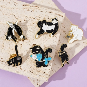Detail of cute cat enamel pins featuring diverse kitten designs on stone display