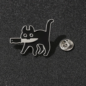 Détail macro du pin's émaillé chat noir avec couteau et fermoir papillon argenté