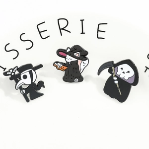 Detailed close-up of plague doctor, wizard cat and grim reaper enamel pins set