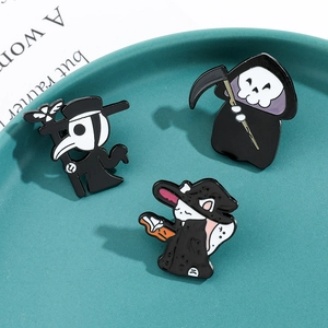 Detailed close-up of gothic enamel pins featuring plague doctor, reaper, and wizard cat
