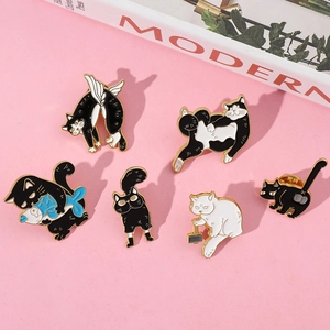 Detail of creative cat enamel pins set featuring a kitten holding a fish and various poses