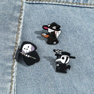Detailed view of Halloween enamel pins with cat wizard, reaper and plague doctor icons
