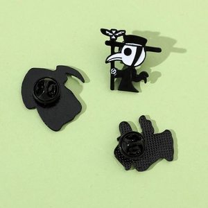 Plague doctor enamel pins in black and white finish featuring a classic bird mask design