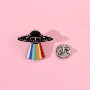 Detailed view of UFO enamel pin with vibrant rainbow beam and silver butterfly clutch