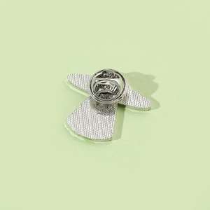 Macro shot showing the butterfly clutch and mesh texture on the silver metal brooch back