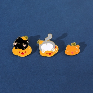 Three-piece Halloween enamel pin set with black cat and pumpkin designs on blue background