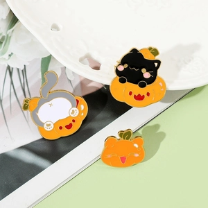 Detailed close-up of three creative Halloween enamel cat pins on a ceramic plate