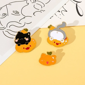Macro detail of three creative Halloween cat and pumpkin enamel pins on a warm display