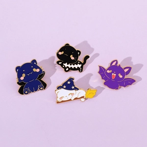 Detailed view of four colorful Halloween cat enamel pins and a bat badge set