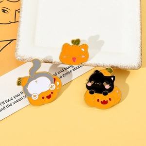Detailed view of three creative Halloween enamel pins featuring black cat and pumpkin motifs