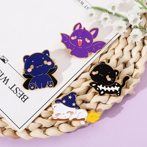 Detail view of four Halloween enamel pins featuring cute cats and bats on a lavender background