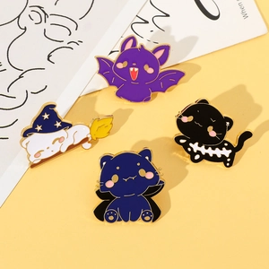 Detail of four Halloween enamel cat pins including bat cat and wizard hat cat badges