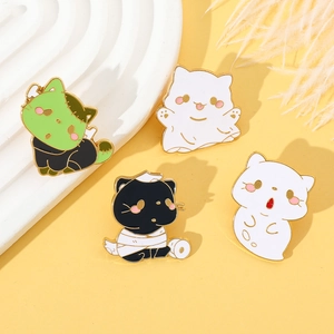 Detail view of colorful Halloween cat enamel pins featuring ghost and mummy designs