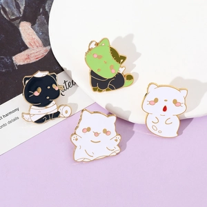 Set of four spooky Halloween enamel cat pins including ghost and mummy designs on a stand