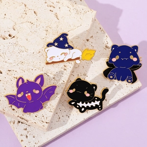 Macro shot of Halloween cartoon cat enamel pins set featuring a wizard cat on a broom