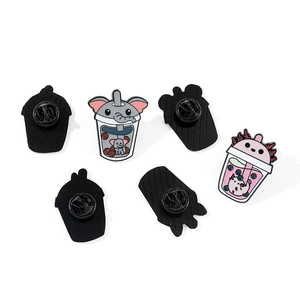 Detailed view of cute cartoon elephant and axolotl milk tea cup enamel pins with back clasps