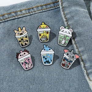 Set of 6 cartoon bubble tea enamel pins with cute animal heads on denim jacket