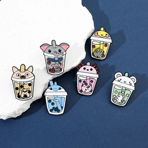 Close-up of cute animal milk tea enamel pins with colorful creative cartoon designs