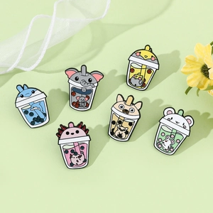 Close-up of six cute animal bubble tea enamel pins on a decorative green background
