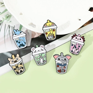 Set of six colorful enamel pins featuring cute animals in bubble tea cups on a table