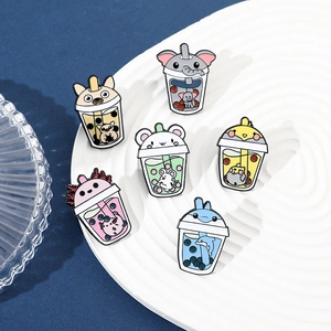 Detailed set of cartoon animal bubble tea enamel pins on a white tray with blue background