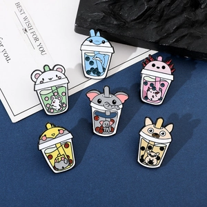 Detail of 6-piece cute animal milk tea enamel pin set on a stylish dark blue background
