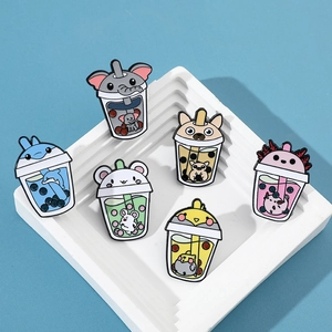 Detailed close-up of six colorful enamel pins featuring cartoon animals in bubble tea cups