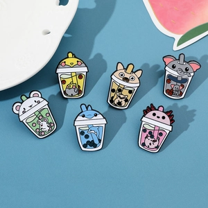 Detailed view of six cartoon animal boba tea enamel pins on a fresh decorative tray