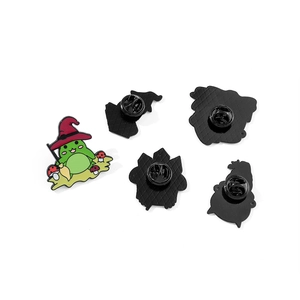 Cartoon magic frog enamel pin set with red wizard hat and mushroom detail for Halloween