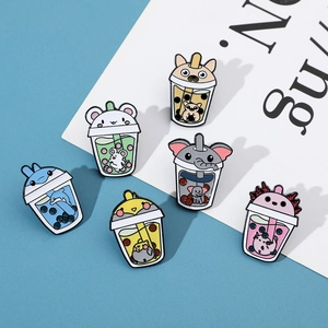 Detail of six creative enamel pins featuring animals inside bubble tea cups