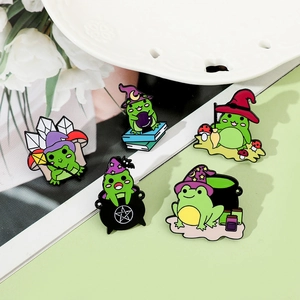 Detailed view of five creative cartoon witch frog enamel pins with magical elements