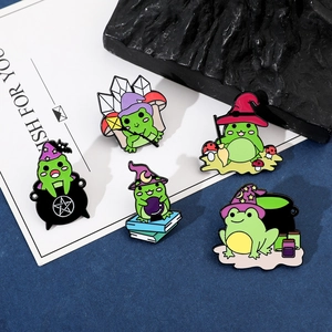 Detail of five creative enamel wizard frog pins with magic hats and cauldron accessories