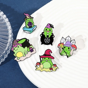 Detailed view of five creative wizard frog enamel pins on a decorative white plate