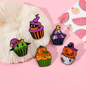 Close-up of five Halloween cupcake enamel pins with pumpkin and skull details