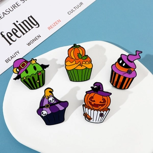 Macro detail of five Halloween cupcake enamel pins with pumpkin and skull designs