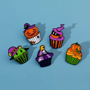 Detailed view of creative Halloween cupcake enamel pins with pumpkin and skull designs