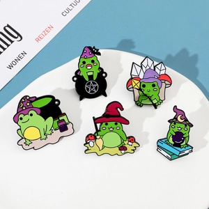 Set of 5 creative magic wizard frog enamel pins displayed on a white tray with blue background