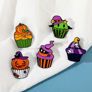 Detailed close-up of a five-piece Halloween cupcake enamel pin set with festive pumpkin motifs