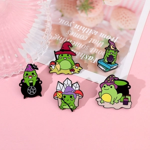 Detailed set of five green magic frog enamel pins with wizard hats and witch accessories
