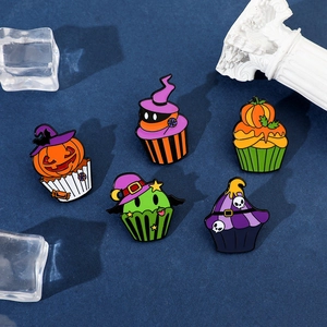 Detailed close-up of 5-piece Halloween cupcake enamel pins with pumpkins and skulls