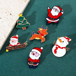 Detailed view of colorful Christmas enamel pins featuring Santa, reindeer, and trees