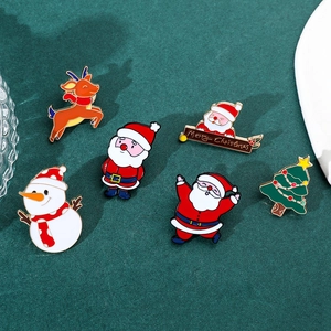 Detail of Christmas enamel pins set featuring Santa Claus, reindeer, and snowman designs