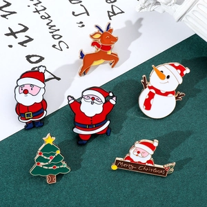 Close-up of 6-piece Christmas enamel pin set featuring Santa, snowman and reindeer