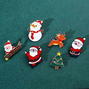 Close-up of colorful enamel Christmas brooch set with Santa, elk and snowman designs