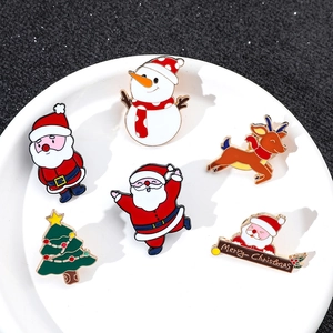 Detail of 6-piece Christmas enamel pin set with Santa, reindeer and tree on ceramic plate
